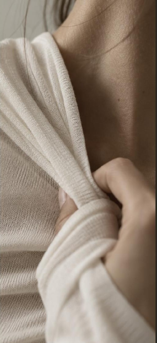 Skin-First Fashion pitch deck thumbnail: close-up of a model in a soft cream knit
